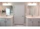 Bright bathroom featuring double vanity sinks, marble floors, and a linen closet for ample storage space at 5714 Pickens Garden Ln, Powder Springs, GA 30127