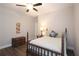 Bright bedroom with wood floors, a four poster bed, and a side table with a lamp at 5714 Pickens Garden Ln, Powder Springs, GA 30127