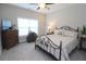 Comfortable bedroom with a bed, a window, and an antique chest for storage space at 5714 Pickens Garden Ln, Powder Springs, GA 30127