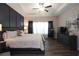 Primary bedroom with dark accent wall, tray ceiling, large window, and ensuite bathroom at 5714 Pickens Garden Ln, Powder Springs, GA 30127
