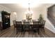 A formal dining room features hardwood flooring, large table, and an elegant lighting fixture at 5714 Pickens Garden Ln, Powder Springs, GA 30127