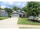Inviting curb appeal with a well-maintained lawn, charming shrubbery, and a classic two-car garage at 5714 Pickens Garden Ln, Powder Springs, GA 30127
