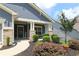 Charming front porch with stone pillars and cozy landscaping, creating a welcoming entrance at 5714 Pickens Garden Ln, Powder Springs, GA 30127