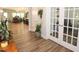 Hallway featuring hardwood floors, access to other living areas, and a glimpse of natural lighting at 5714 Pickens Garden Ln, Powder Springs, GA 30127