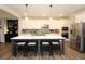 Well-equipped kitchen with a large island, stainless steel appliances, white cabinets, and modern backsplash at 5714 Pickens Garden Ln, Powder Springs, GA 30127