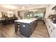Open-concept kitchen with a large island, stainless steel appliances, white cabinets, and modern finishes at 5714 Pickens Garden Ln, Powder Springs, GA 30127