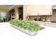 The kitchen island sink is surrounded by white countertops, a box of greenery and modern appliances at 5714 Pickens Garden Ln, Powder Springs, GA 30127