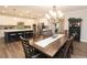 Open-concept kitchen features white cabinets, stainless steel appliances, and a large island with barstool seating at 5714 Pickens Garden Ln, Powder Springs, GA 30127