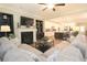 Spacious open concept living room that opens to the kitchen featuring built-in bookshelves and fireplace at 5714 Pickens Garden Ln, Powder Springs, GA 30127