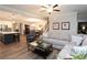 Open concept living room with wood floors, comfortable seating and open to the kitchen and dining areas at 5714 Pickens Garden Ln, Powder Springs, GA 30127