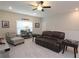 Comfortable living room with a leather sofa, a ceiling fan, and a side table at 5714 Pickens Garden Ln, Powder Springs, GA 30127