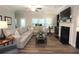 Spacious living room features a fireplace, large windows and a comfortable sectional sofa and wood flooring at 5714 Pickens Garden Ln, Powder Springs, GA 30127