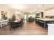 Bright open concept living space with hardwood floors, a dining table, kitchen island and seating, and living room at 5714 Pickens Garden Ln, Powder Springs, GA 30127