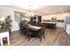 An open concept living space featuring a dining table, kitchen island, and comfortable living room with fireplace at 5714 Pickens Garden Ln, Powder Springs, GA 30127