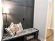 Cozy mudroom with patterned tile seat, storage shelf, and convenient hooks and lamp at 5714 Pickens Garden Ln, Powder Springs, GA 30127