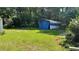 View of green backyard, complete with shed and vegetation at 8436 Magnolia Dr, Jonesboro, GA 30238