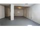 View of the basement featuring white walls, painted concrete floors, and a support pillar at 8436 Magnolia Dr, Jonesboro, GA 30238