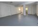 Spacious basement with white walls and painted concrete floors at 8436 Magnolia Dr, Jonesboro, GA 30238