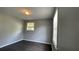 Bedroom with wood-look flooring and natural light from two windows at 8436 Magnolia Dr, Jonesboro, GA 30238