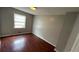 Bedroom with wood-look flooring and natural light from a window at 8436 Magnolia Dr, Jonesboro, GA 30238