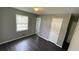 Bedroom with wood-look flooring, natural light, and closet at 8436 Magnolia Dr, Jonesboro, GA 30238