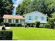 Charming home with white siding, well-manicured lawn, and mature trees providing ample shade at 8436 Magnolia Dr, Jonesboro, GA 30238