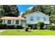 Charming home with white siding, well-manicured lawn, and mature trees providing ample shade at 8436 Magnolia Dr, Jonesboro, GA 30238