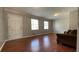 Bright living room with wood flooring and a white front door at 8436 Magnolia Dr, Jonesboro, GA 30238