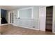 Living room with decorative wall trim, tile floors, and a view of the staircase at 8436 Magnolia Dr, Jonesboro, GA 30238