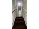 Carpeted staircase with decorative trim and light fixture leading to the upper level at 8436 Magnolia Dr, Jonesboro, GA 30238