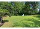 Lush green backyard offering ample space for recreation and relaxation, complete with mature trees at 1409 Georgia Ave, East Point, GA 30344