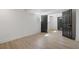Bright basement featuring light wood flooring, neutral paint and black painted doors at 1409 Georgia Ave, East Point, GA 30344