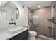 Modern bathroom with a sleek vanity, large mirror, and glass-enclosed shower at 1409 Georgia Ave, East Point, GA 30344