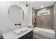 Modern bathroom features updated fixtures and shower over bath at 1409 Georgia Ave, East Point, GA 30344