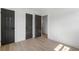 Bedroom featuring hardwood floors, fresh white walls, and three sleek paneled interior doors at 1409 Georgia Ave, East Point, GA 30344