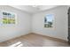 Bright bedroom with beautiful hardwood floors, crisp white walls, and natural light from two windows at 1409 Georgia Ave, East Point, GA 30344