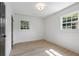 Well-lit bedroom showcasing beautiful hardwood floors, pristine walls, and dual windows at 1409 Georgia Ave, East Point, GA 30344