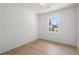 This bedroom features hardwood floors, a window, and neutral paint at 1409 Georgia Ave, East Point, GA 30344