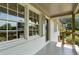 Cozy porch view features a grey painted floor, brick and wood accents, with a view of the neighborhood at 1409 Georgia Ave, East Point, GA 30344