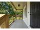 Inviting front porch showcasing natural wood railings and views of the surrounding greenery at 1409 Georgia Ave, East Point, GA 30344