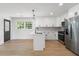 Updated kitchen with stainless steel appliances, a center island, and light wood flooring at 1409 Georgia Ave, East Point, GA 30344