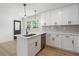 Modern kitchen features white cabinets, stainless steel appliances, and eat-in kitchen island at 1409 Georgia Ave, East Point, GA 30344