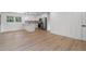 Open-concept kitchen and living area with hardwood floors and modern stainless steel appliances at 1409 Georgia Ave, East Point, GA 30344