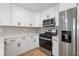 This kitchen features stainless steel appliances and white countertops and cabinets at 1409 Georgia Ave, East Point, GA 30344