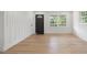 Bright, open living area with stylish wood flooring, a modern door, and large windows at 1409 Georgia Ave, East Point, GA 30344