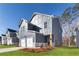 Two-story home featuring a two-car garage, gray siding, and a well-maintained lawn at 145 Weldon Rd, Mcdonough, GA 30253