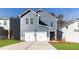 Charming two-story home with a two-car garage, modern siding, and a concrete driveway at 145 Weldon Rd, Mcdonough, GA 30253