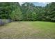 A large backyard with mature trees, perfect for outdoor activities and relaxation at 231 Silver Fox Trl, Dallas, GA 30157