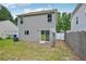 Back exterior view of the home with sliding door to yard and privacy fence at 231 Silver Fox Trl, Dallas, GA 30157