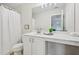 This bathroom features a white vanity, large mirror, and shower-tub combo at 231 Silver Fox Trl, Dallas, GA 30157
